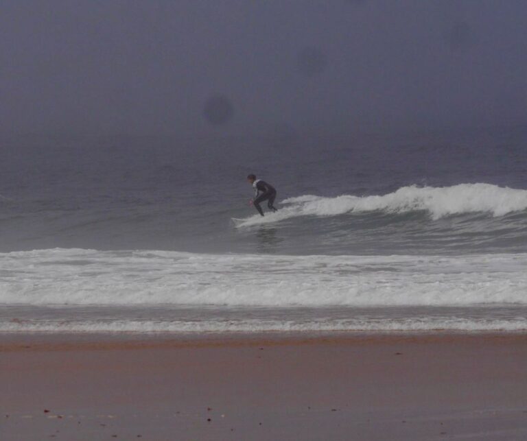 foggy surf surf guide algarve surfgirl going right