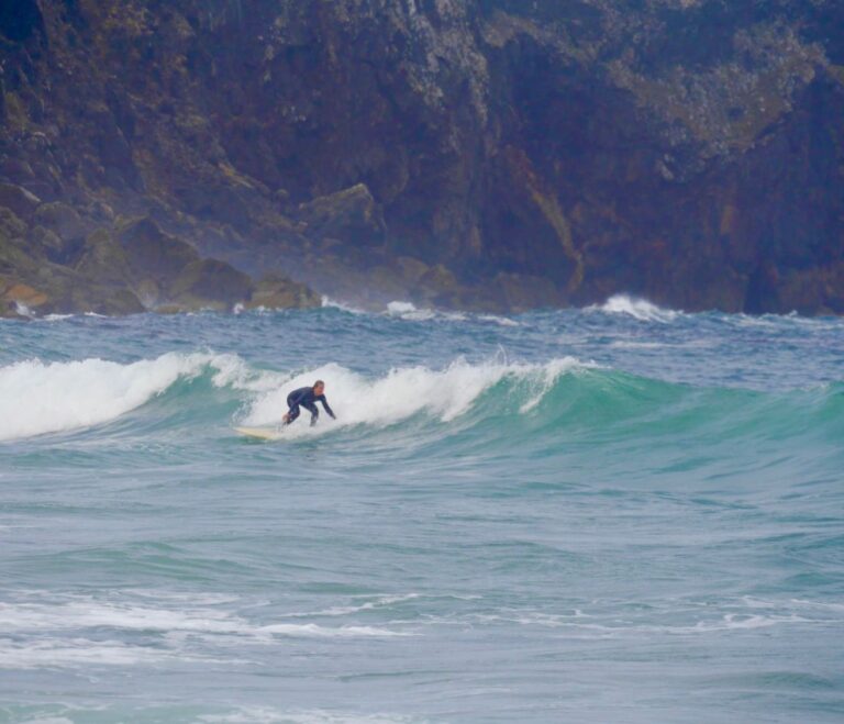 surfer girl charging a tricky forecast with surf guide algarve