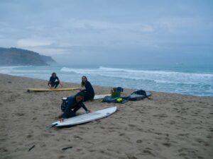 girl squad surf guide algarve waxing the surfboards at burgau