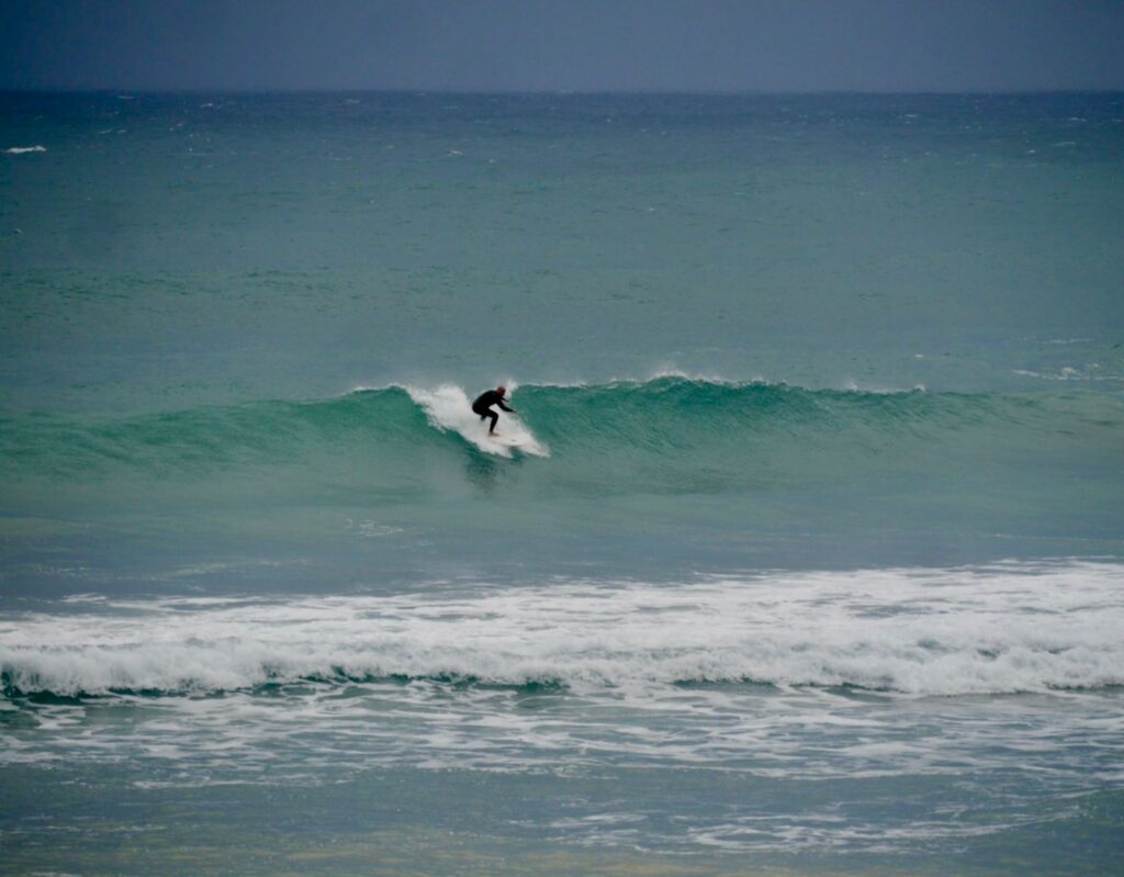 surf guide algarve guest taking off west coast moody sky